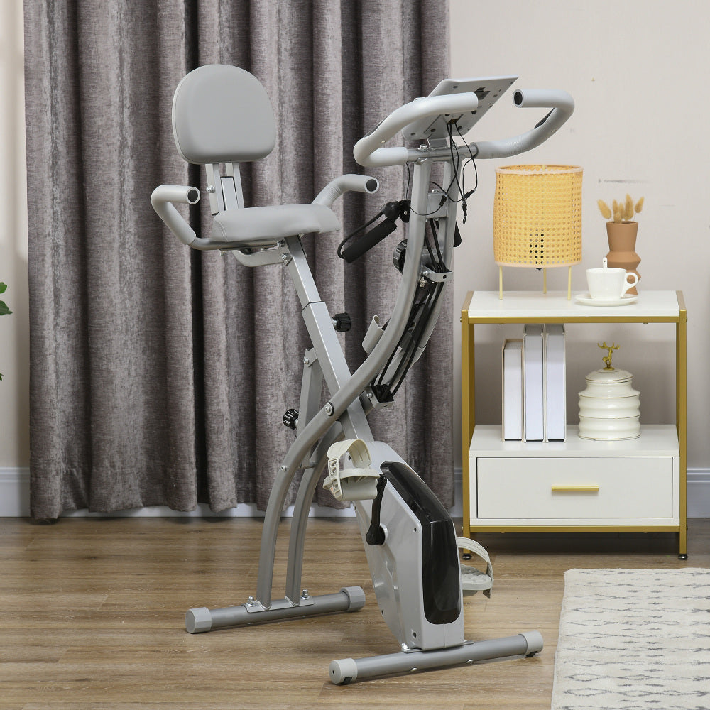 H102 Heimtrainer Grau – Faltbares X-Bike im modernen Wohnzimmer aufgestellt