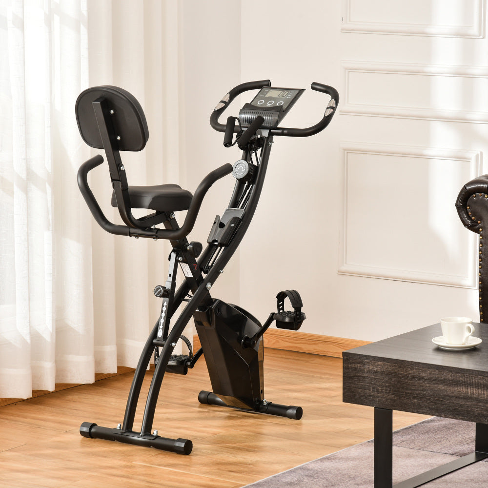 H102 Heimtrainer Schwarz – Faltbares X-Bike im Wohnzimmer aufgestellt